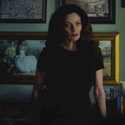 Woman In Black Shirt With Painting When Will The World Learn GIF