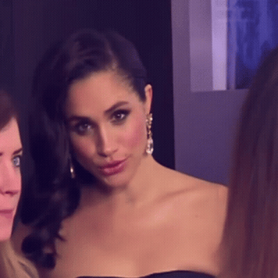 Woman In Black Strapless Dress And Earrings Posing GIF