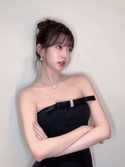 Woman In Black Strapless Dress With Eyes Closed GIF