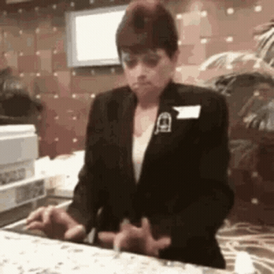 Woman In Black Suit At Restaurant Counter GIF