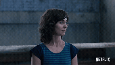 Woman In Black Suit Dancing Before Points Of Impact Board GIF
