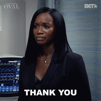 Woman In Black Suit Giving Thank You Sign GIF