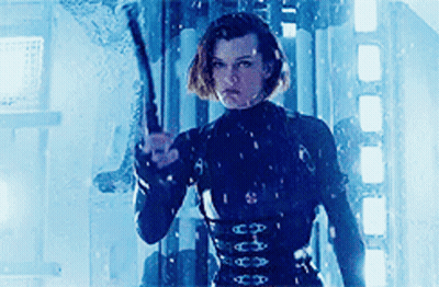 Woman In Black Suit Holding Gun GIF