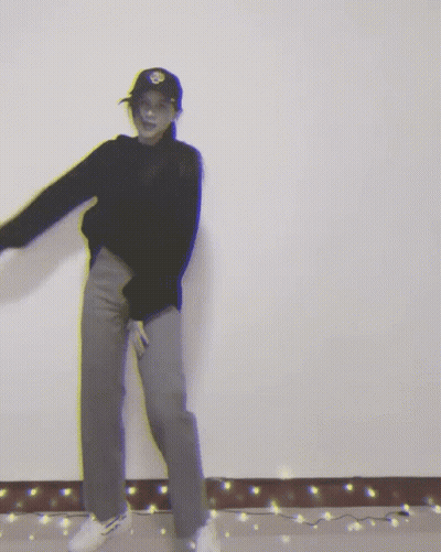 Woman In Black Sweater And Hat Dancing GIF