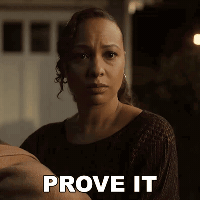 Woman In Black Sweater Holding Baby Says Prove It GIF
