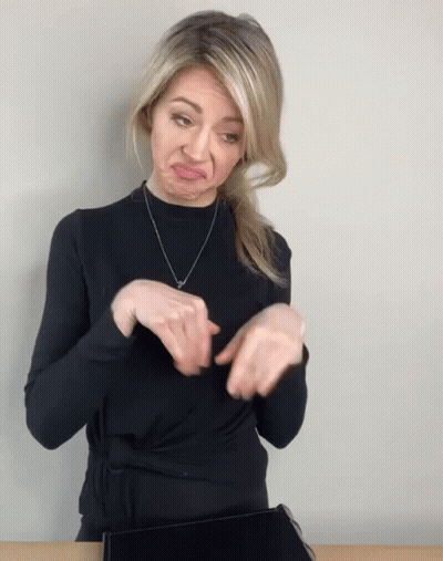 Woman In Black Sweater Making Face With Hands GIF