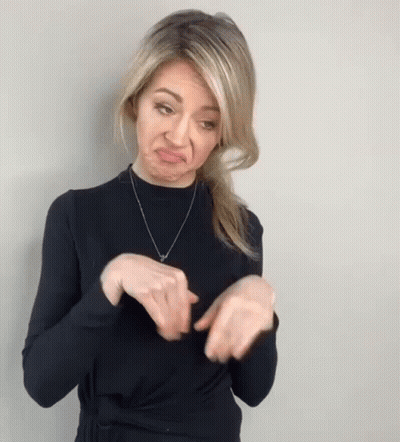 Woman In Black Sweater Making Funny Face With Hands GIF
