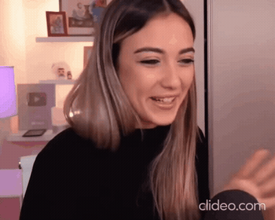 Woman in Black Sweater Smiling at Camera Clideo.com