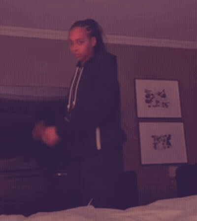 Woman In Black Sweatshirt With Letter A Holding Green Bottle GIF