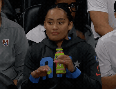 Woman In Black Sweatshirt With Letter A Holding Green Bottle GIF