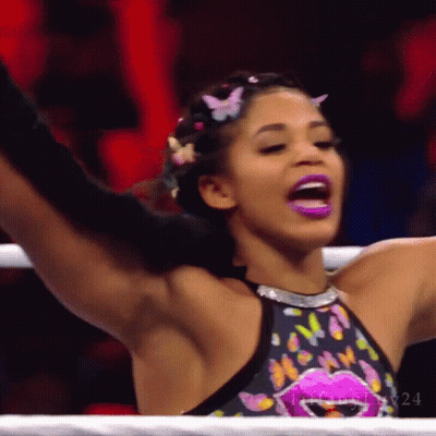 Woman In Black Tank Top And Gold Hoop Earrings Smiling GIF