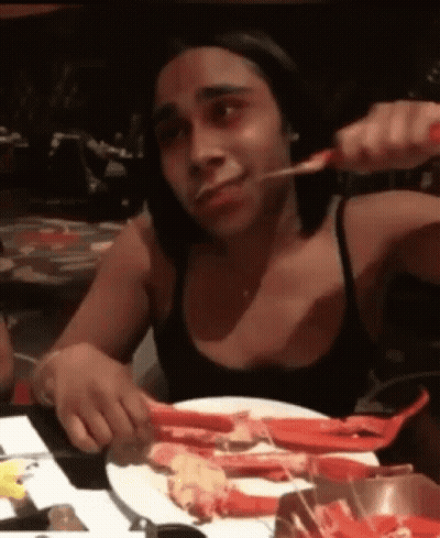 Woman In Black Tank Top Eating Crab Legs GIF