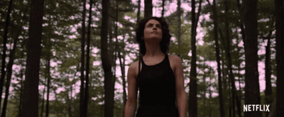 Woman In Black Tank Top In Forest With Netflix GIF