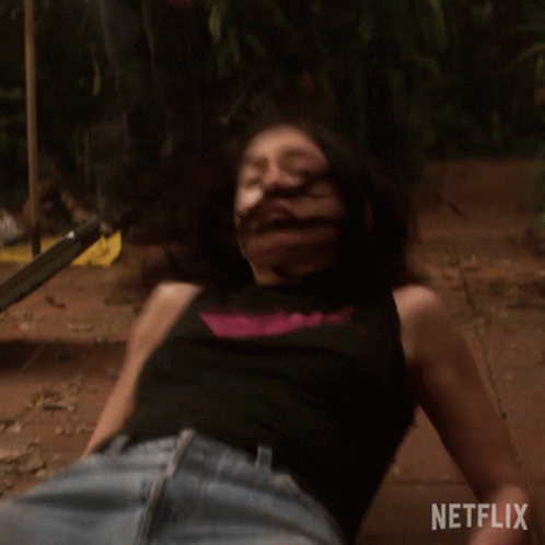 Woman In Black Tank Top Laying On Ground With Netflix Logo GIF