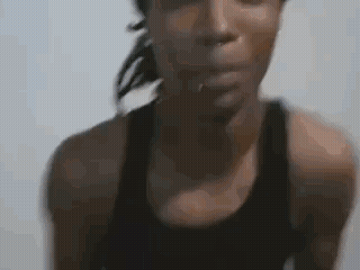 Woman In Black Tank Top Looking At Camera GIF
