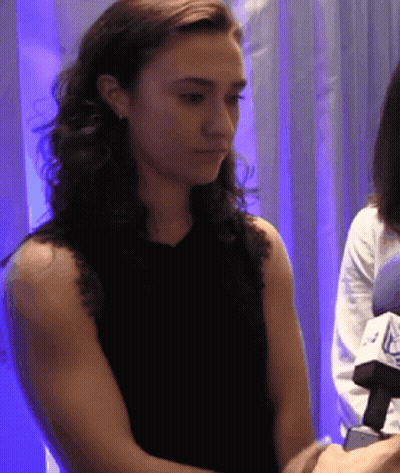 Woman In Black Tank Top Looking Down GIF