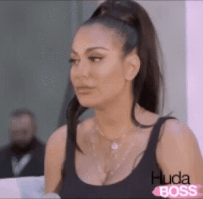 Woman In Black Tank Top Ponytail Making Face GIF