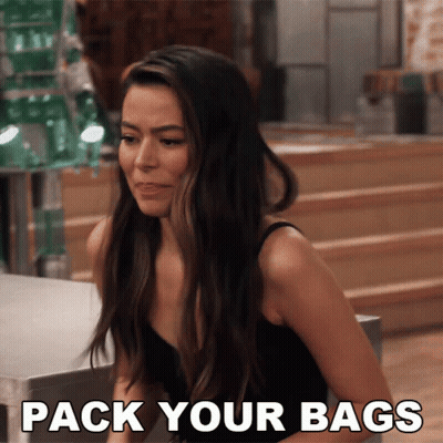 Woman In Black Tank Top Sitting At Table Saying Pack Your Bags GIF