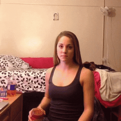 Woman In Black Tank Top Sitting GIF