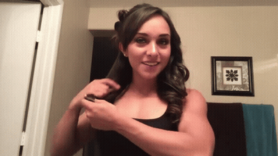Woman In Black Tank Top Smiling Holding Hair GIF