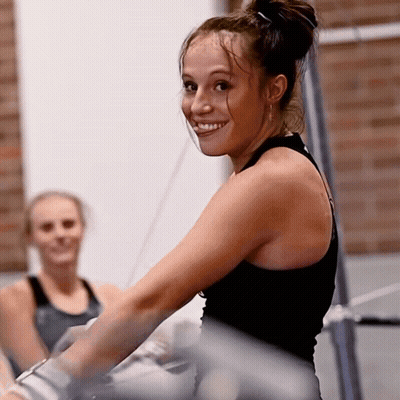 Woman In Black Tank Top Smiling In Gym GIF