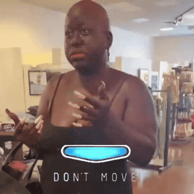 Woman In Black Tank Top Standing By 'Don't Move' Sign GIF
