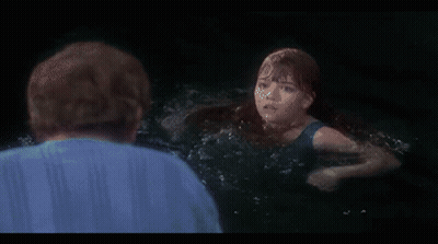 Woman In Black Tank Top Swimming In Ocean GIF