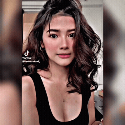 Woman In Black Tank Top TikTok On Shoulder GIF