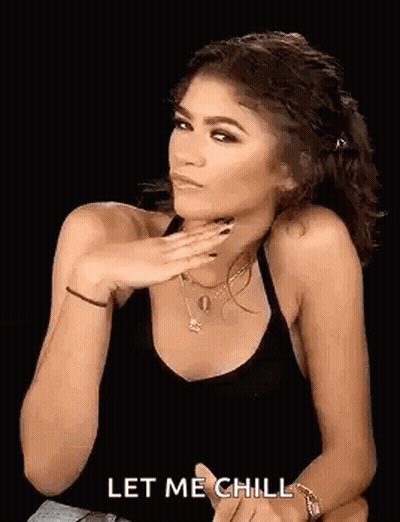 Woman In Black Tank Top With Hand On Chin GIF