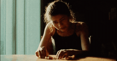 Woman In Black Tank Top With Hands On Table GIF