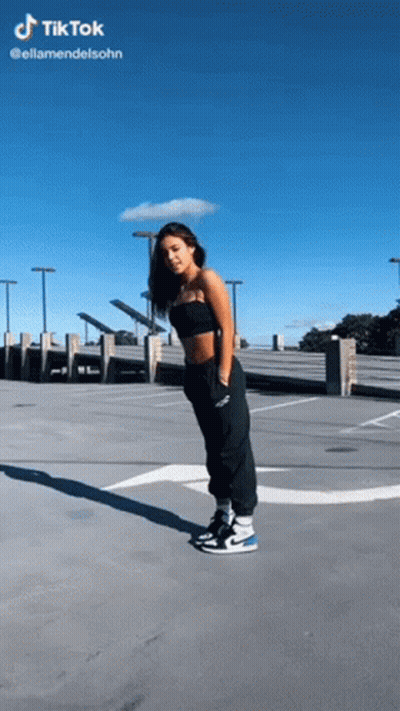 Woman in Black Top and Black Pants in Parking Lot