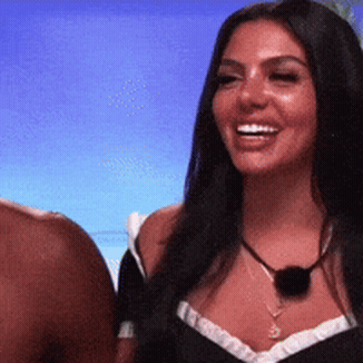 Woman In Black Top And Necklace Smiling GIF