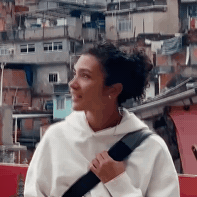 Woman In Black Top And Pants Standing In Front Of Mirror GIF