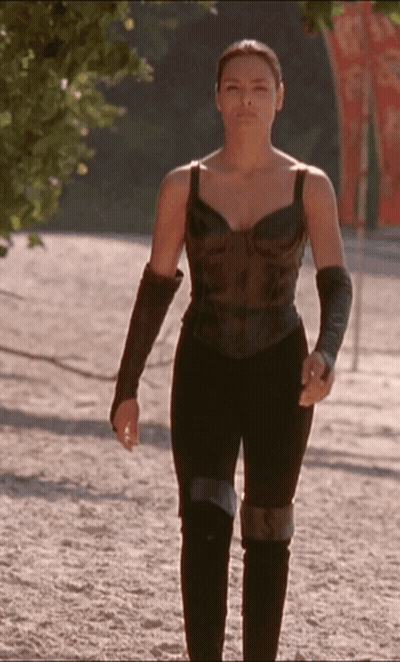 Woman In Black Top And Pants Walking Down Dirt Path GIF