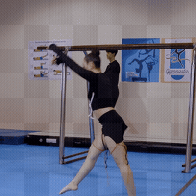 Woman In Black Top And Shorts Standing On Blue Mat GIF