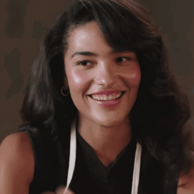 Woman In Black Top And White Apron Smiling GIF