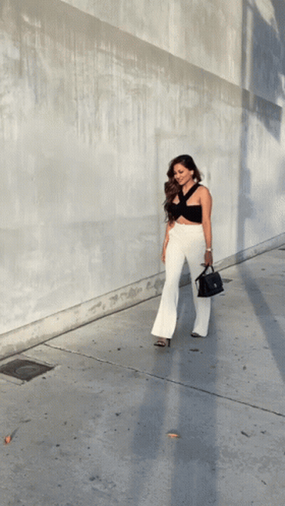 Woman In Black Top And White Pants Walking GIF