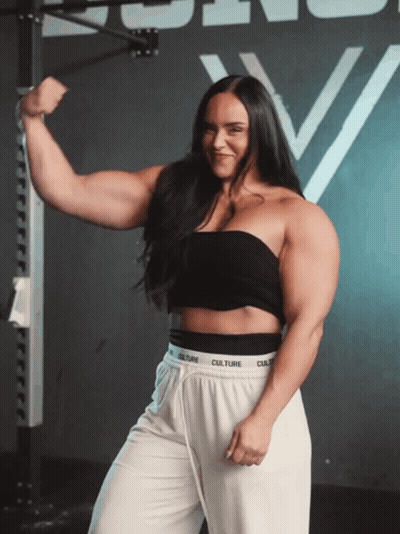 Woman In Black Top And White Pants With Culture Waistband GIF