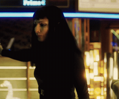 Woman In Black Top Standing In Front Of Prime Sign GIF