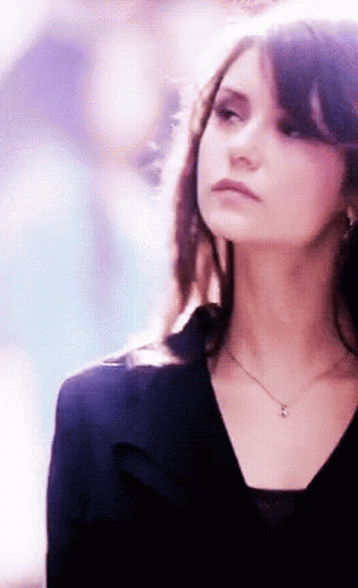Woman In Black Top With Pendant Necklace GIF