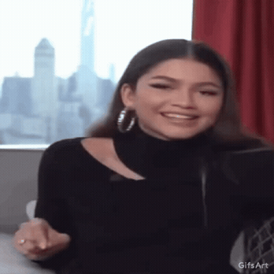 Woman In Black Turtleneck And Hoop Earrings GIF