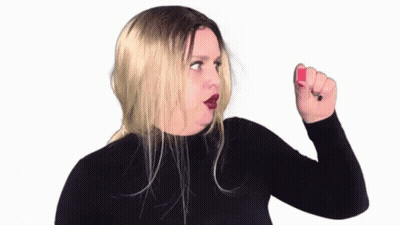 Woman In Black Turtleneck Holding Red Nail Polish GIF