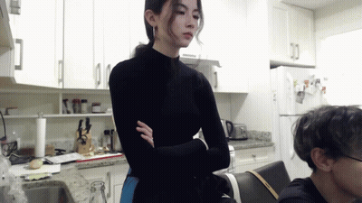 Woman In Black Turtleneck In Kitchen GIF