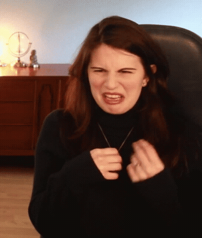 Woman In Black Turtleneck Making Face GIF