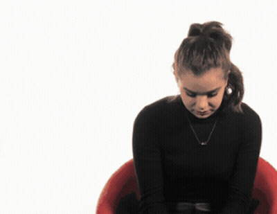 Woman In Black Turtleneck Sitting In Red Chair GIF
