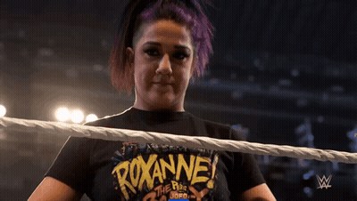 Woman In Black Turtleneck Smiling And Making Funny Face GIF