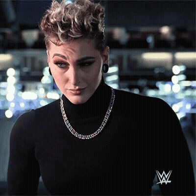 Woman In Black Turtleneck With Wrestling Logo GIF
