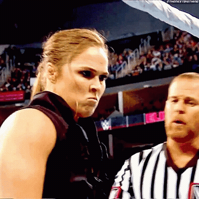 Woman In Black Vest Next To Man In Striped Shirt GIF