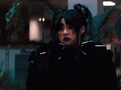 Woman In Black Wig And Black Sweater GIF