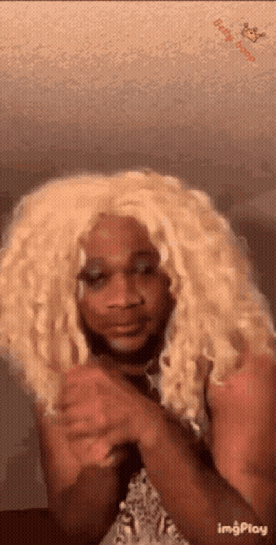 Woman In Blonde Wig Making Funny Face GIF